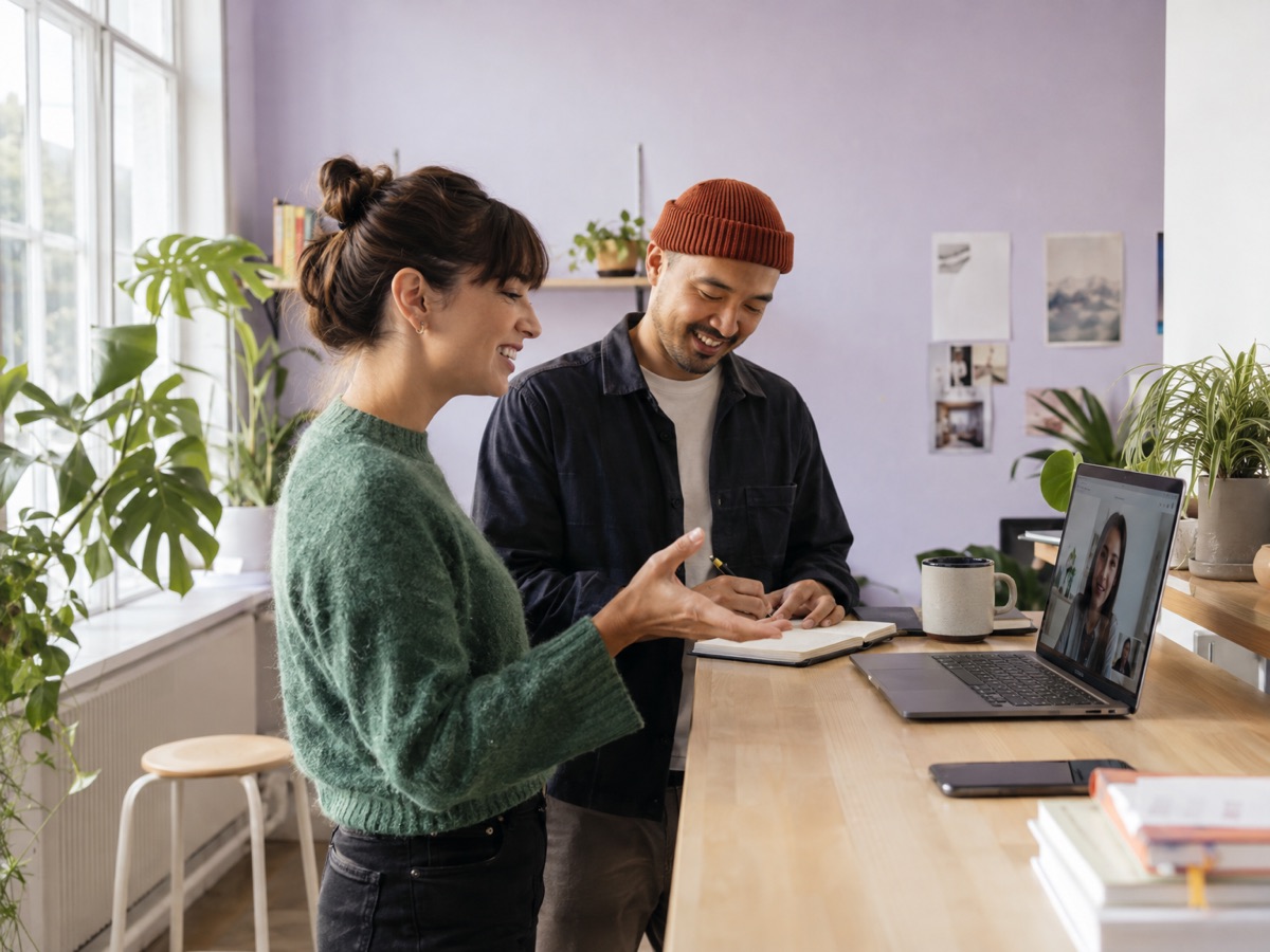Two people at a small agency on a video call with a client